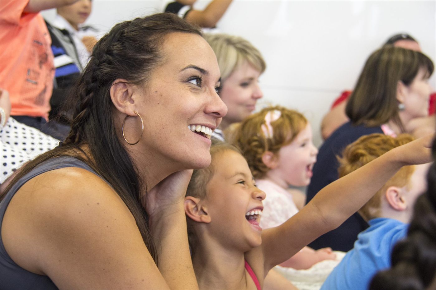 Adults and children laughing together during a Jimmy Marvel show