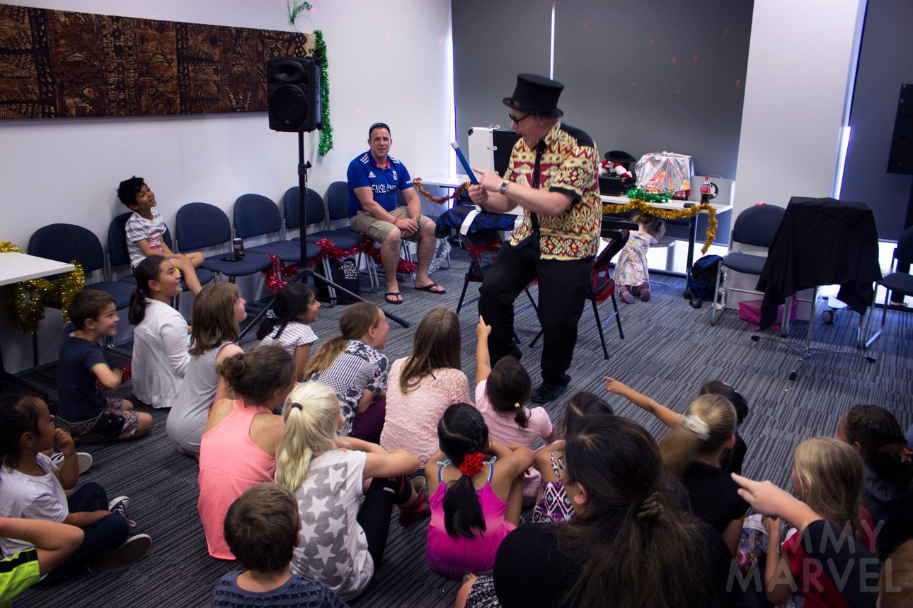 Children enjoying Jimmy Marvel's interactive show at an organisation event