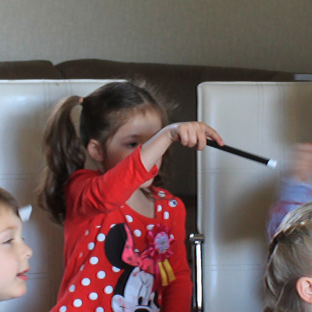 A child joining the magic with a wand