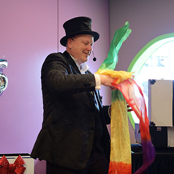 Jimmy Marvel producing a large rainbow streamer